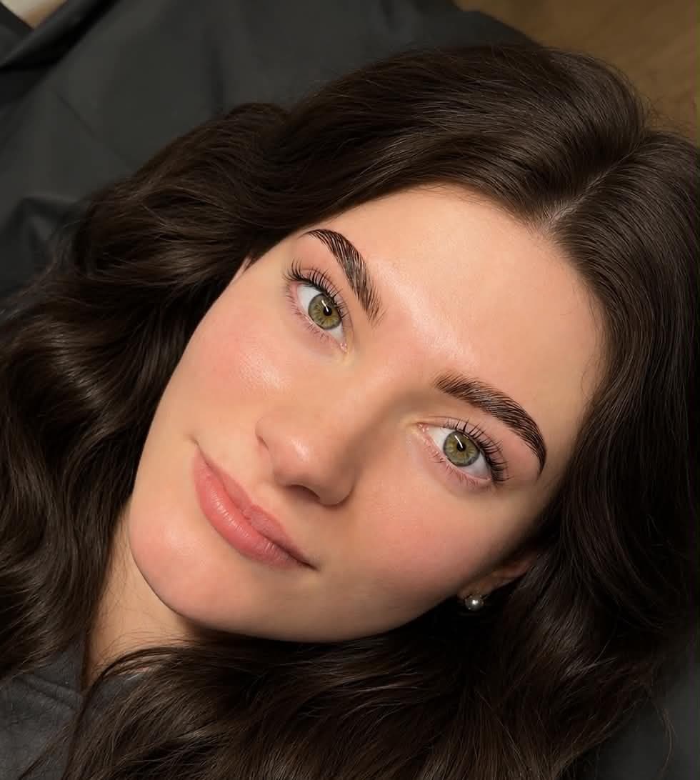 Monica showing a soft brow lamination result in the studio